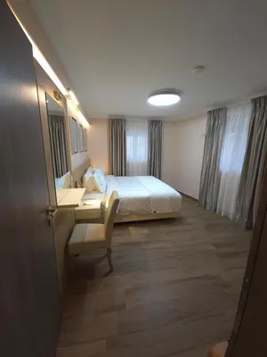 a hotel room with a bed and a desk and a mirror at Breeze Apartment in Chania Town