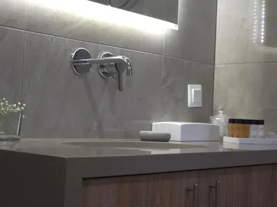a bathroom counter with a sink and ailver at Breeze Apartment in Chania Town