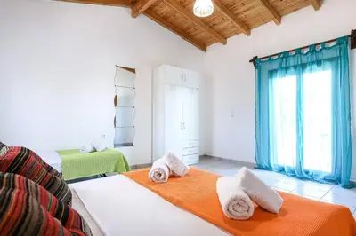 a bedroom with a bed with towels on it at Alkis Hideaway in Kissamos