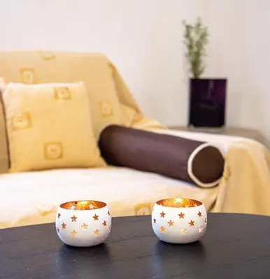 two cups sitting on a table in front of a bed at Alkis Hideaway in Kissamos