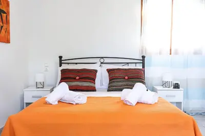 a bedroom with a bed with two towels on it at Alkis Hideaway in Kissamos