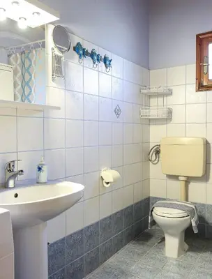 a bathroom with a toilet and a sink at Alkis Hideaway in Kissamos
