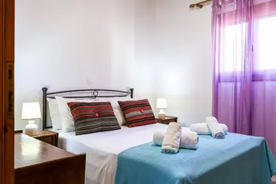 a bedroom with a bed with two pillows on it at Alkis Hideaway in Kissamos
