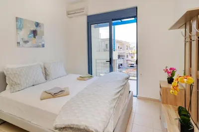 a bedroom with a bed and a large window at Villa Kimi -New listing with sea views! in Kalyves