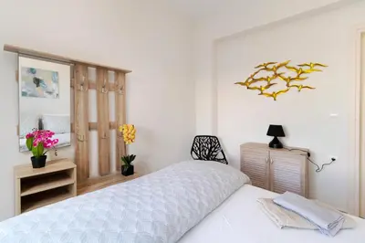a white bedroom with a bed and a mirror at Villa Kimi -New listing with sea views! in Kalyves