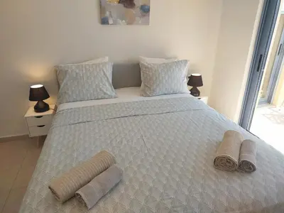 a bedroom with a large bed with two towels on it at Villa Kimi -New listing with sea views! in Kalyves