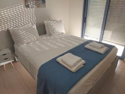 a bedroom with a large bed with two towels on it at Villa Kimi -New listing with sea views! in Kalyves