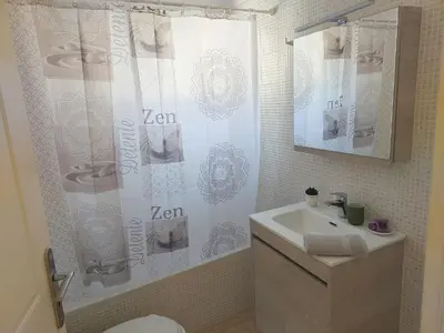 a bathroom with a sink and a shower curtain at Villa Kimi -New listing with sea views! in Kalyves