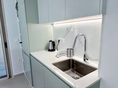 a kitchen with a sink and a counter top at Azure Loft - 3min walk to beach, 10min to Old Town in Chania Town