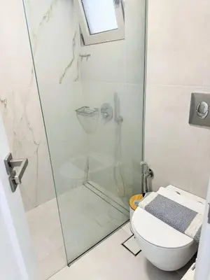 a bathroom with a shower and a toilet at Azure Loft - 3min walk to beach, 10min to Old Town in Chania Town