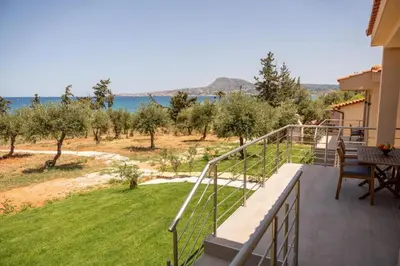 a balcony of a house with a view of the ocean at Terra Blue Suites - Nefeli in Kalyves