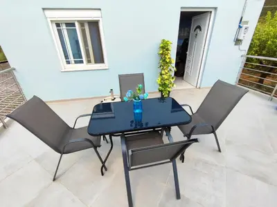a blue table and two chairs on a patio at Nature House Vlatos in Vlátos