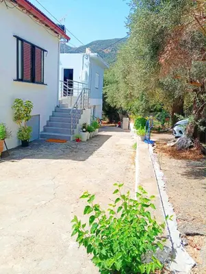 a house with stairs and a yard with a house at Nature House Vlatos in Vlátos