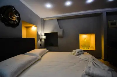 a bedroom with a large bed with towels on it at Vasiliki Venetian suites in Chania Town