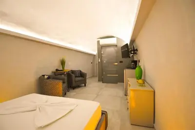 a room with a bed and a living room at Vasiliki Venetian suites in Chania Town