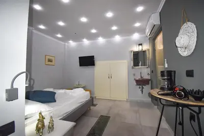 a small room with a bed and a table at Vasiliki Venetian suites in Chania Town