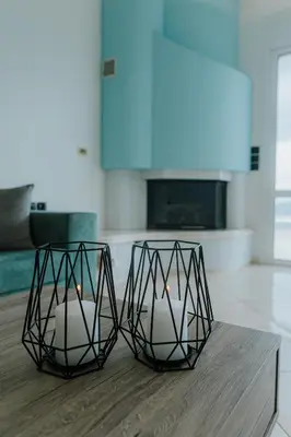 two candle holders on a table in a living room at AITHRA seaside in Arónion
