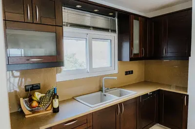 a kitchen with a sink and a window at AITHRA seaside in Arónion