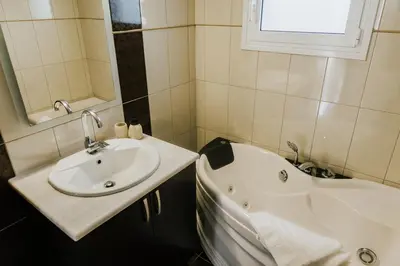 a bathroom with a sink and a bath tub at AITHRA seaside in Arónion
