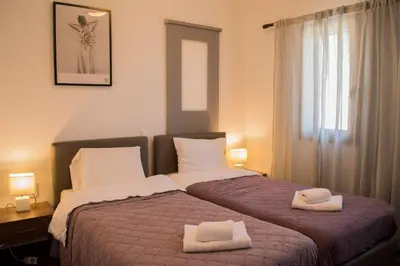 a bedroom with a bed with two towels on it at Villa Marie Homeleader in Delimanolianá