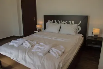 a bed with white towels on top of it at Villa Marie Homeleader in Delimanolianá