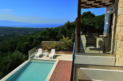 a house with a swimming pool with a view at Villa Marie Homeleader in Delimanolianá