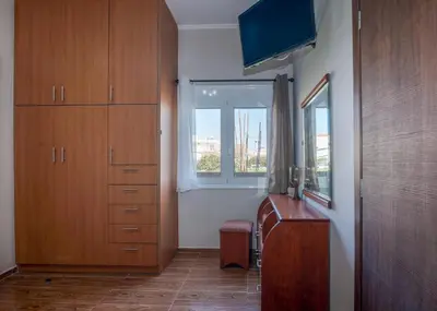 a room with a desk and a window and a dresser at Margie's Apartments in Kissamos