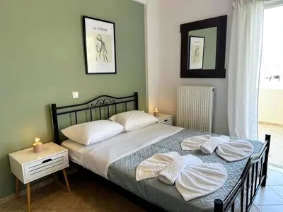 a bedroom with a bed with two pillows on it at Son of the Beach Apartment - 20sec walk to beach in Chania Town
