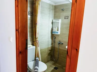 a bathroom with a shower with a toilet and a sink at Son of the Beach Apartment - 20sec walk to beach in Chania Town