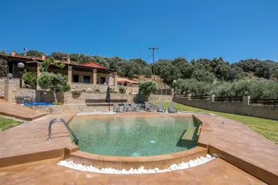 a swimming pool in a yard with a house at Villa Dimmare by PosarelliVillas in Kissamos