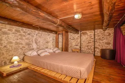 a bedroom with a bed in a room with wooden ceilings at Villa Dimmare by PosarelliVillas in Kissamos