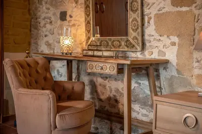 a bathroom with a chair and a mirror at Villa Dimmare by PosarelliVillas in Kissamos