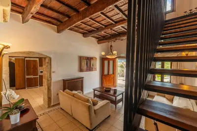 a living room with a couch and a staircase at Villa Faye by PosarelliVillas in Metókhion