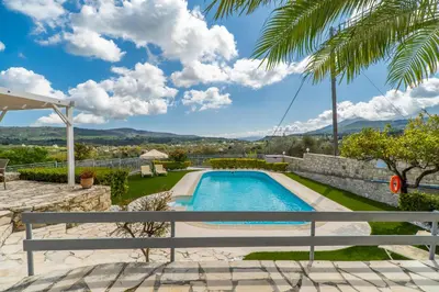 a pool in the backyard of a villa at Villa Faye by PosarelliVillas in Metókhion