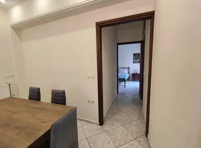 a dining room with a table and chairs and a hallway at Angie A1 close to the beach by 8essentially in Chania Town