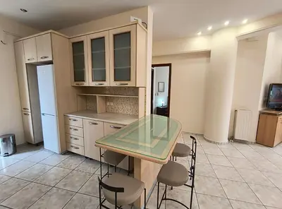 a kitchen with a glass table and some chairs at Angie A1 close to the beach by 8essentially in Chania Town