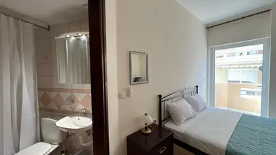 a bedroom with a bed and a bathroom with a sink at Angie A1 close to the beach by 8essentially in Chania Town