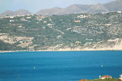 a large body of water with mountains in the background at Dans une villa avec piscine privée, calme, proche des plages, vues mer et montagnes in Tsivarás