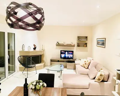 a living room with a couch and a tv at Villa Astrea in Sinoikismós Mamounianá