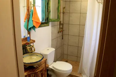 a small bathroom with a toilet and a sink at Village Villa Marika Drapanias in Drapaniás