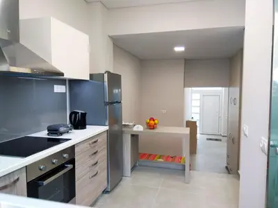 a kitchen with a refrigerator and a counter top at Dimitrios Cozy Apartment in Chania Town