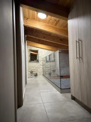 a hallway with a walk in shower in a house at Villa Maria in Stalos