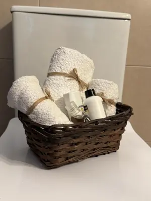 a basket with towels and soap on a toilet at Villa Maria in Stalos