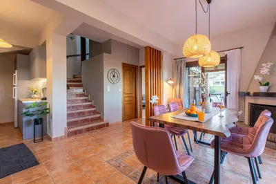 a dining room with a table and chairs at Dimosthenis by Vintage Travel in Stalos
