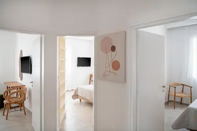 a white room with a bedroom with a bed at Amelia Luxury Living Mantaka in Chania Town