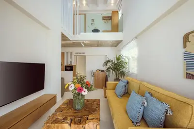 a living room with a couch and a tv at Ethereal White Villas in Gramvousá