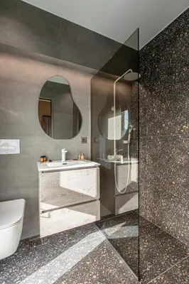 a bathroom with a sink and a toilet and a mirror at Villa Alargo Heated Pool in Katokhórion