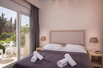 a bedroom with a bed and a large window at Mear Luxury Holiday Homes - Cretan Sunny Gems in Kountoura Selino