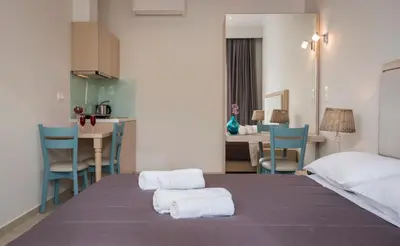a bedroom with a bed with two towels on it at Mear Luxury Holiday Homes - Cretan Sunny Gems in Kountoura Selino