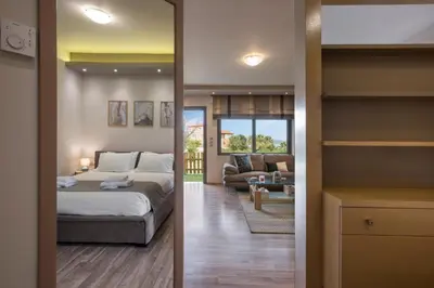 a bedroom with a bed and a living room at Zen Luxury Studio in Kalamaki Chanion